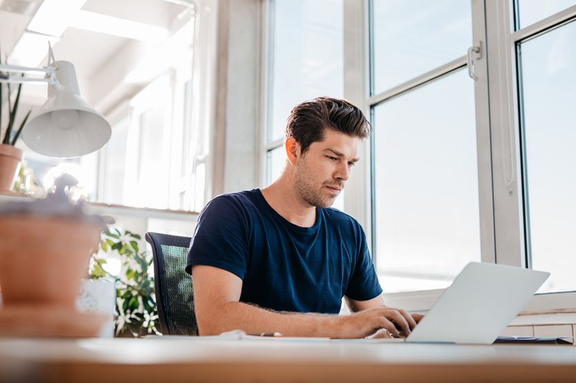 man working on laptop left to right