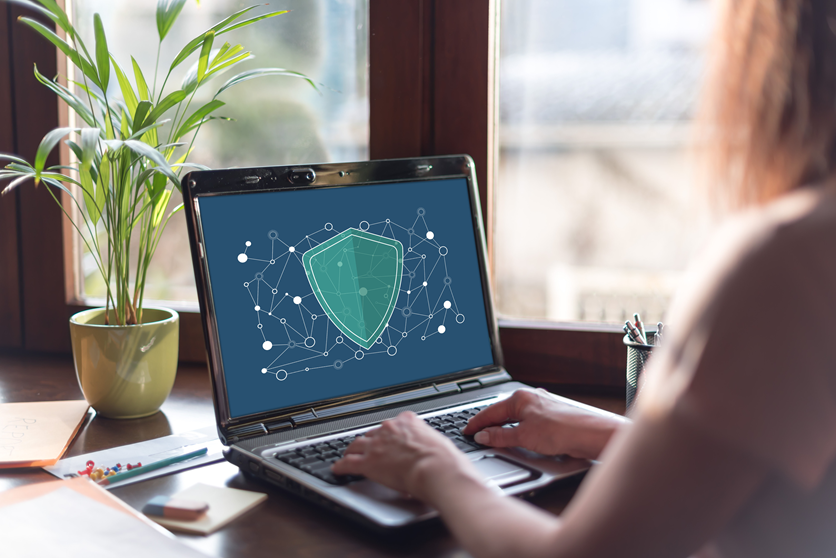 woman looking at screen with shield on it