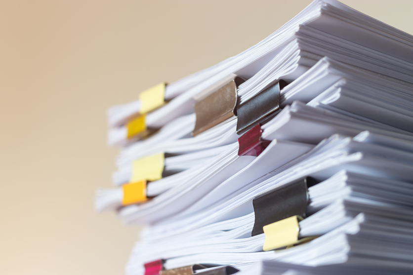 stack of documents with clamps